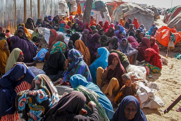 FILE - Somalis who fled drought-stricken areas sit at a makeshift camp on the outskirts of the capital Mogadishu, Somalia on Feb. 4, 2022. (AP Photo/Farah Abdi Warsameh, File)