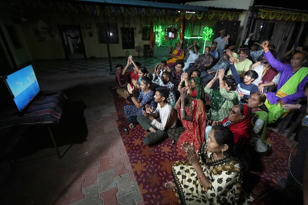 Villagers cheer while watching a NASA live stream as they gather to pray for the safe return of NASA astronaut Suni Williams from the International Space Station (ISS), at a temple in her ancestral village Jhulasan in Mehsana district of Gujarat state, India, Wednesday, March 19, 2025. (AP Photo/Ajit Solanki)