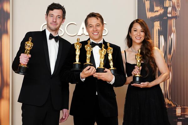 Alex Coco, from left, winner of the award for best picture for "Anora," Sean Baker, winner of the awards for best original screenplay, best film editing, best director, and best picture for "Anora," and Samantha Quan, winner of the award for best picture for "Anora," pose in the press room at the Oscars on Sunday, March 2, 2025, at the Dolby Theatre in Los Angeles. (Photo by Jordan Strauss/Invision/AP)