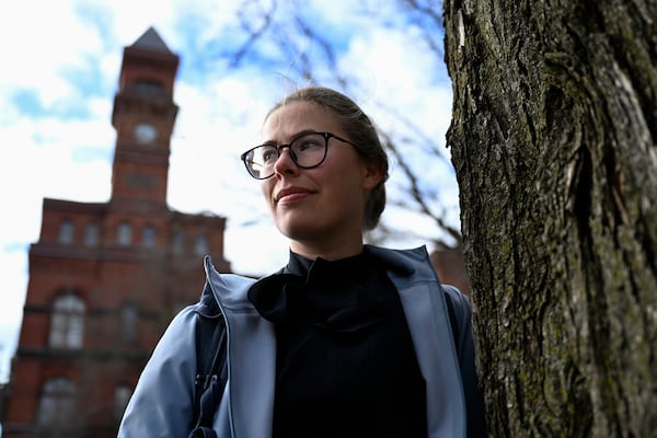 Sydney Smith, who lost her job due to DOGE cuts, stands in front of the Sydney Yates building that houses the Forest Service on Thursday, March. 6, 2025, in Washington. (AP Photo/John McDonnell)