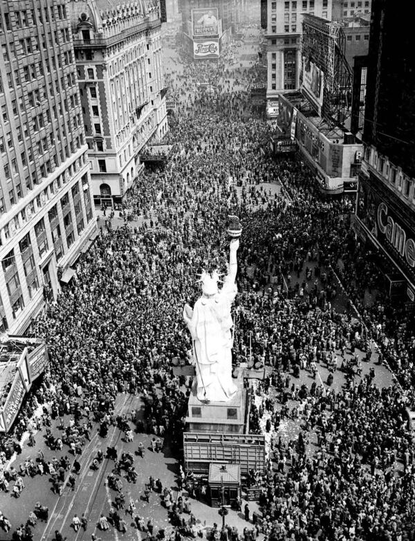 People crowd Times Square at 42nd Street in New York City on May 8, 1945, as the V-E Day celebration continues into the night. (AP Photo/Matty Zimmerman, File)