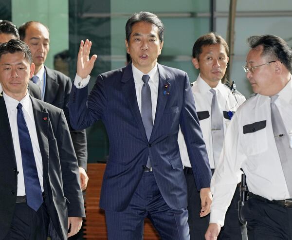 Japan's Agriculture Minister Taku Eto, center, arrives at the prime minister's office in Tokyo Wednesday, May 21, 2025. (Kyodo News via AP)