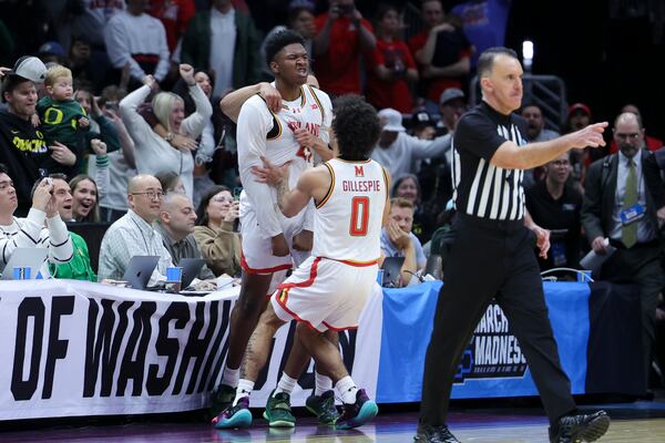 Maryland center Derik Queen, center, reacts with guard Ja'Kobi Gillespie after making the game-winning shot against Colorado State during the second half in the second round of the NCAA college basketball tournament, Sunday, March 23, 2025, in Seattle. (AP Photo/Ryan Sun)