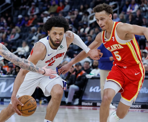 Detroit Pistons guard Cade Cunningham, left, drives to the basket against Atlanta Hawks guard Dyson Daniels (5) during the second half of an NBA basketball game Monday, Feb. 3, 2025, in Detroit. (AP Photo/Duane Burleson)