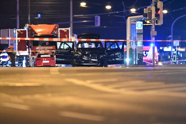 A damaged car sits with its doors open after a driver plowed into a busy Christmas market in Magdeburg, Germany, early Saturday, Dec. 21, 2024. (Hendrik Schmidt/dpa via AP)