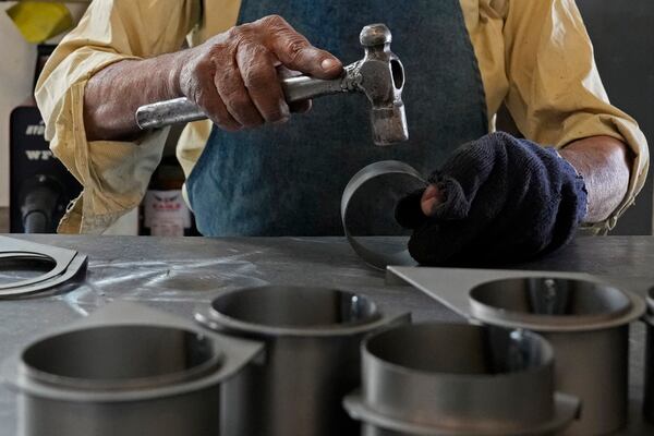 A blacksmith works with Indian-made steel at a factory in a suburb of Bengaluru, India, Thursday, Feb. 27, 2025. (AP Photo/Aijaz Rahi)