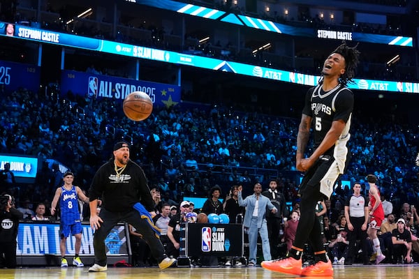 San Antonio Spurs guard Stephon Castle reacts after dunking during the slam dunk contest at the NBA basketball All-Star Saturday night festivities Saturday, Feb. 15, 2025, in San Francisco. (AP Photo/Godofredo A. Vásquez)