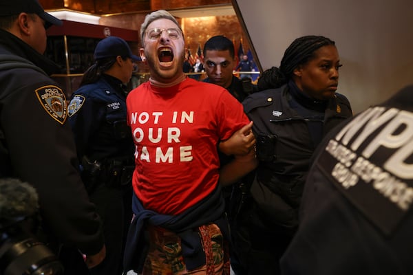 New York Police officers arrest a demonstrator from the group, Jewish Voice for Peace, who protested inside Trump Tower in support of Columbia graduate student Mahmoud Khalil, Thursday, March 13, 2025, in New York. (AP Photo/Yuki Iwamura)