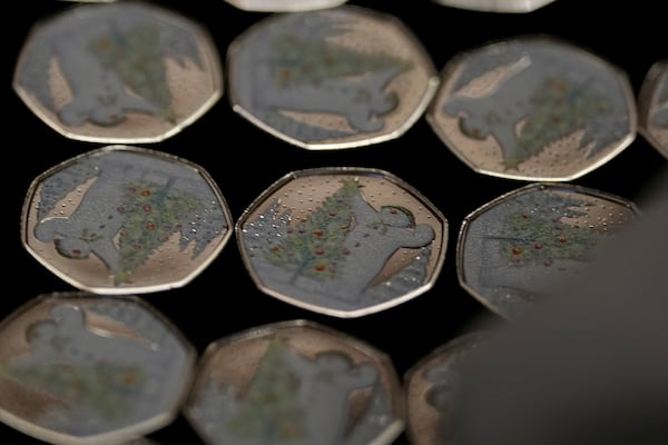 50 Pence Snowman coins are on display during the "Trial of the Pyx,'' a ceremony that dates to the 12th Century in which coins are weighed in order to make certain they are up to standard, at the Goldsmiths' Hall in London, Tuesday, Feb. 11, 2025.(AP Photo/Frank Augstein)