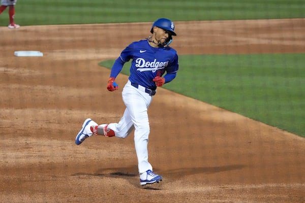 Los Angeles Dodgers shortstop Mookie Betts rounds the bases after hitting a home run during the third inning of a spring training baseball game against the Cincinnati Reds, Tuesday, March. 4, 2025, in Phoenix. (AP Photo/Darryl Webb)