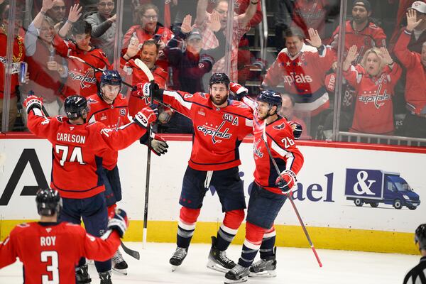 Washington Capitals right wing Tom Wilson, second from right, celebrates his goal in the third period of Game 2 of a second-round NHL hockey playoff series against the Carolina Hurricanes, Thursday, May 8, 2025, in Washington. (AP Photo/Nick Wass)