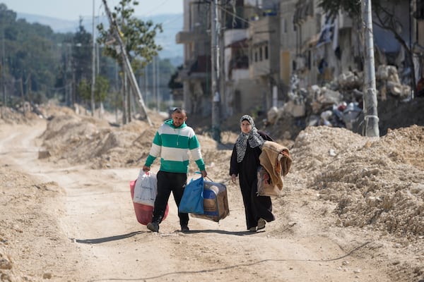 Residents of the West Bank urban refugee camp of Nur Shams evacuate their homes and carry their belongings as the Israeli military continues its operation in the area on Wednesday, Feb. 26, 2025. (AP Photo/Majdi Mohammed)