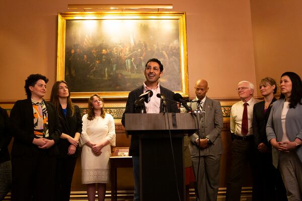 Mohsen Mahdawi, center, speaks during a press conference announcing the launch of the Vermont Immigration Legal Defense Fund in the Cedar Creek Reception Room at the Vermont State House on Thursday, May 8, 2025, in Montpelier, Vt. (AP Photo/Alex Driehaus)