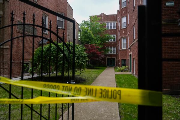 Police tape is tied around a gate outside of a building at an address listed in public records as the home of Elias Rodriguez, who police identified as the suspect in the killing of two staff members of the Israeli Embassy in Washington, Thursday, May 22, 2025, in Chicago. (AP Photo/Erin Hooley)