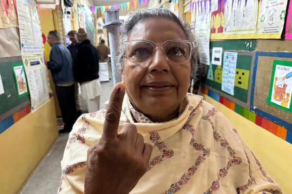 A woman shows an indelible ink mark on her finger after casting her vote for the capital’s state legislature election at a polling booth in New Delhi, India, Wednesday, Feb. 5, 2025. (AP Photo/Shonal Ganguly)