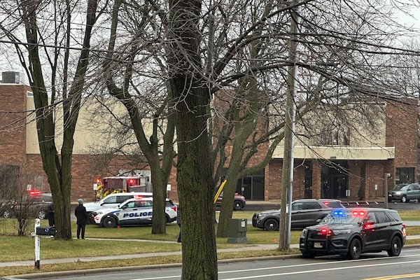 Emergency vehicles are parked outside the Abundant Life Christian School in Madison, Wis., where multiple injuries were reported following a shooting, Monday, Dec. 16, 2024. (AP Photo/Kathleen Foody)