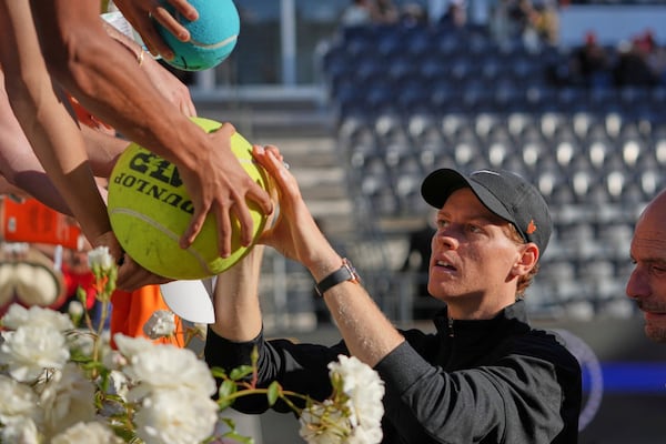 Italy's Jannik Sinner signs autographs after beating Netherlands' Jesper De Jong, at the end of their tennis match at the Italian Open at the Foro Italico, in Rome, Monday, May 12, 2025. (AP Photo/Alessandra Tarantino)