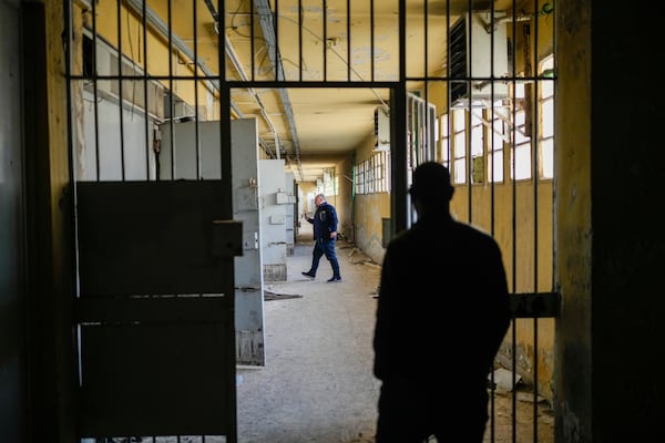 Two men walk along the cells gallery of the infamous Saydnaya military prison on the outskirts of Damascus, Syria, Sunday Jan. 12, 2025. (AP Photo/Mosa'ab Elshamy)