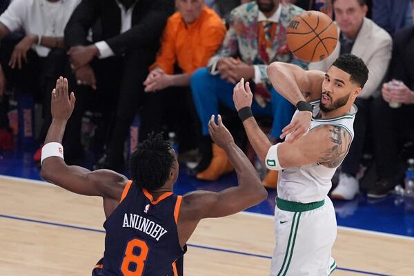 Boston Celtics' Jayson Tatum (0) passes away from New York Knicks' OG Anunoby (8) during the first half of Game 4 in the Eastern Conference semifinals of the NBA basketball playoffs Monday, May 12, 2025, in New York. (AP Photo/Frank Franklin II)