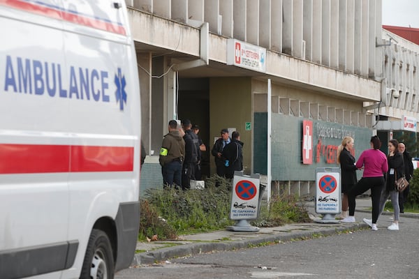 People wait in front of the hospital in the town of Kocani, North Macedonia, Sunday, March 16, 2025, after a massive fire in a nightclub. (AP Photo/Boris Grdanoski)