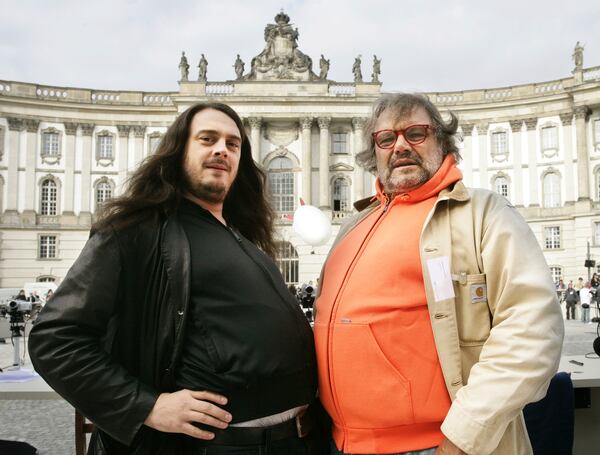 FILE - German artist Jonathan Meese, left, and Italian photographer Oliviero Toscani, pose during the "Table of the Free Voices" event in Berlin, Saturday, Sept. 9, 2006. (AP Photo/Jan Bauer, File)