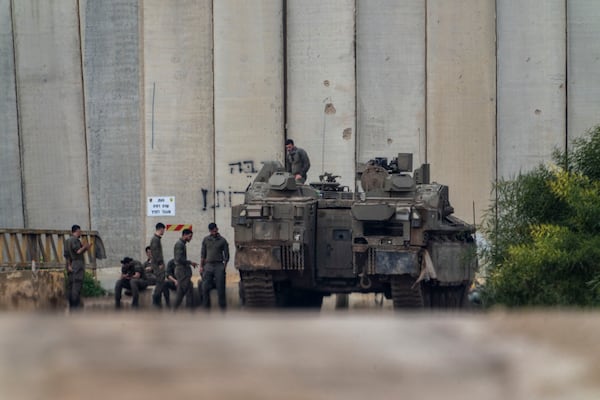 Israeli soldiers gather by the border with the Gaza Strip, in southern Israel, Tuesday, Feb.11, 2025. (AP Photo/Ariel Schalit)