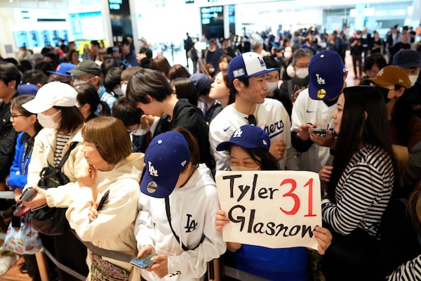 Fans of Los Angeles Dodgers wait for the team arrival at Tokyo International Airport Thursday, March 13, 2025, in Tokyo, as Los Angeles Dodgers is scheduled to play their MLB opening games against Chicago Cubs in Tokyo on March 18-19. (AP Photo/Hiro Komae)