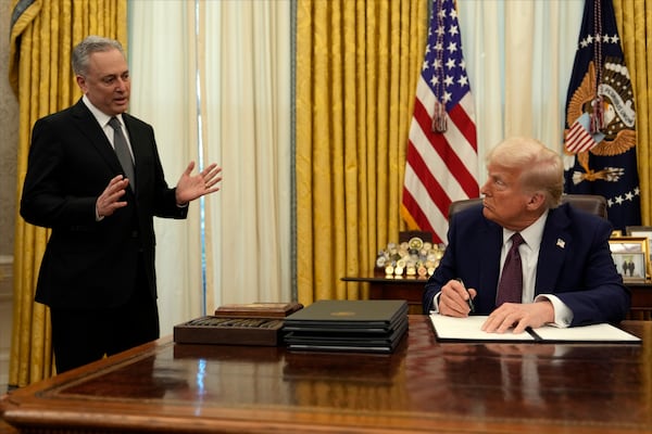 FILE - President Donald Trump listens to White House adviser David Sacks as he signs an executive order regarding cryptocurrency in the Oval Office of the White House, Thursday, Jan. 23, 2025, in Washington. (AP Photo/Ben Curtis, File)