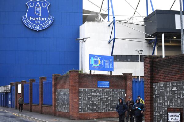 People walk outside Goodison Park as the Premier League soccer match between Everton and Liverpool is called off due to storm Darragh at Goodison Park, in Liverpool, England, Saturday Dec 7, 2024. (AP Photo/Rui Vieira)