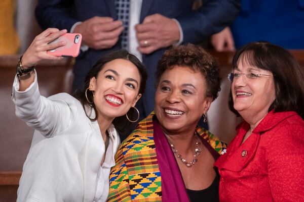 FILE—Rep. Alexandria Ocasio-Cortez, left, a freshman Democrat representing New York's 14th Congressional District, takes a selfie with Rep. Barbara Lee, D-Calif., center, and Rep. Ann McLane Kuster, D-N.H, on the first day of the 116th Congress with Democrats holding the majority under the leadership of Rep. Nancy Pelosi of California as speaker of the House, at the Capitol in Washington, Thursday, Jan. 3, 2019. (AP Photo/J. Scott Applewhite, File)