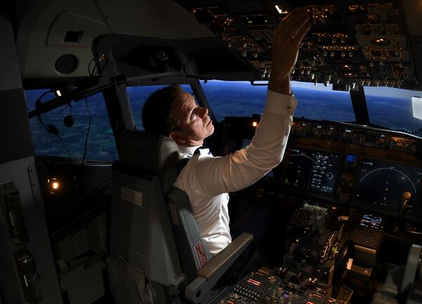 Capt. Miles Morgan, managing director of flight training for United Airlines, flies a simulator at the company's training campus in Denver, Friday, May 16, 2025. (AP Photo/Thomas Peipert)