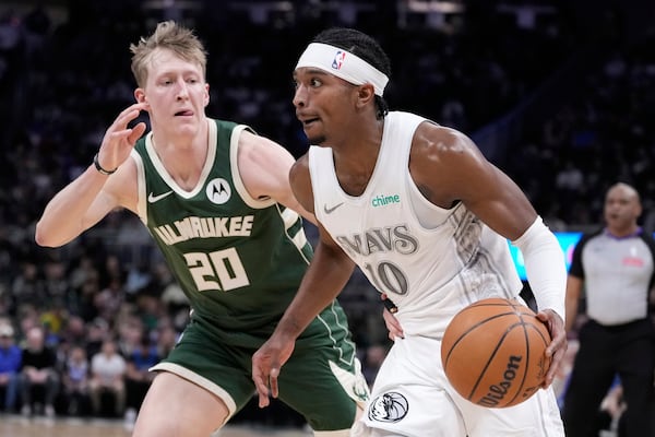 Dallas Mavericks' Brandon Williams tries to get past Milwaukee Bucks' AJ Green during the first half of an NBA basketball game Wednesday, March 5, 2025, in Milwaukee. (AP Photo/Morry Gash)