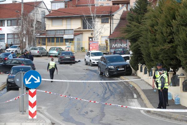 Police officers block a road near a nightclub after a massive fire in the town of Kocani, North Macedonia, Sunday, March 16, 2025. (AP Photo/Boris Grdanoski)