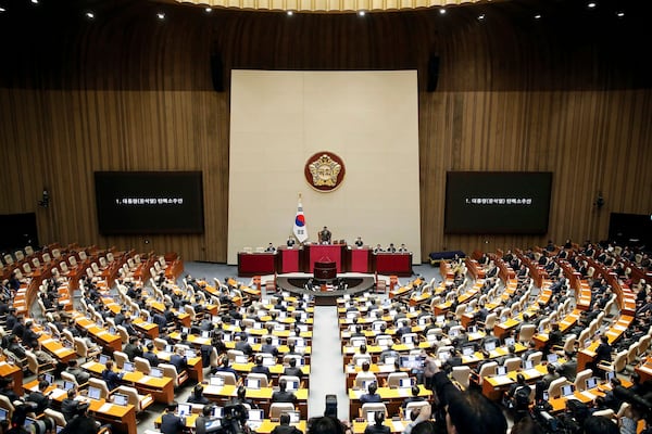 FILE - South Korean lawmakers attend during a plenary session of the impeachment vote of President Yoon Suk Yeol at the National Assembly in Seoul, on Dec. 14, 2024. (Woohae Cho/Pool Photo via AP, File)