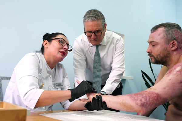 British Prime Minister Keir Starmer visits a hospital as a staff member meets with an injured patient, a Ukrainian service member, in Kyiv, Ukraine Thursday, Jan. 16, 2025. (Carl Court/Pool Photo via AP)