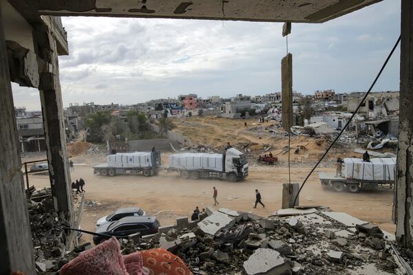 Humanitarian aid trucks enter through the Kerem Shalom crossing from Egypt into the Gaza Strip, in Rafah, Wednesday, Jan. 22, 2025, days after the ceasefire deal between Israel and Hamas came into effect. (AP Photo/Jehad Alshrafi)