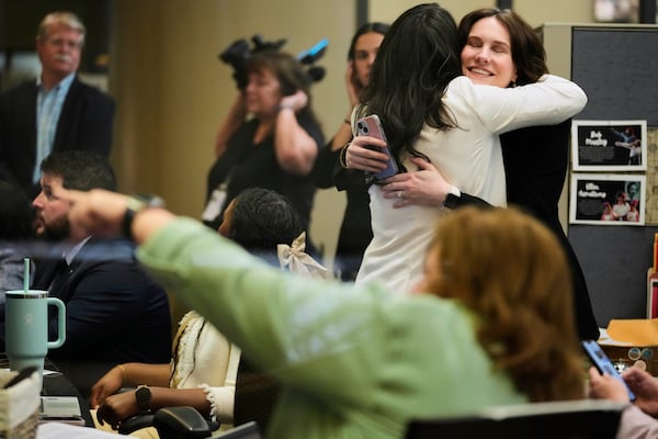 NASA employees react on Tuesday, March 18, 2025, in Houston after watching astronauts splash down off the coast of Florida. (AP Photo/Ashley Landis)