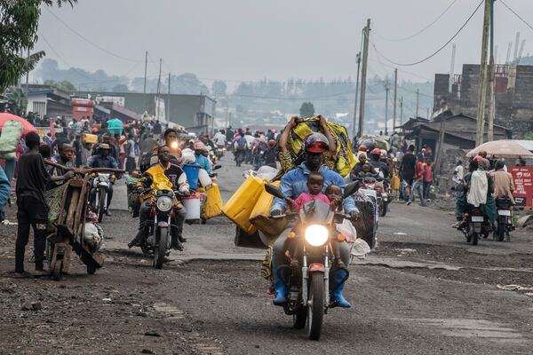 People displaced by the fighting with M23 rebels make their way to the center of Goma, Democratic Republic of the Congo, Sunday, Jan. 26, 2025. (AP Photo/Moses Sawasawa)