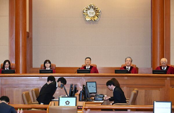 South Korea's Constitutional Court's judges, from left, Jung Jung-mi, Lee Mi-son, acting Chief Justice Moon Hyung-bae, Kim Hyung-du and Cheong Hyung-sik sit for the first formal hearing of a trial on the validity of President Yoon Suk Yeol's impeachment by the National Assembly at the constitutional court of Korea in Seoul, South Korea, Tuesday, Jan. 14, 2025. (Kim Min-Hee/Pool Photo via AP)