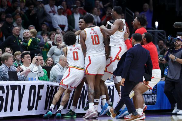 Maryland center Derik Queen, center, reacts with teammates after making the game-winning shot against Colorado State during the second half in the second round of the NCAA college basketball tournament, Sunday, March 23, 2025, in Seattle. (AP Photo/Ryan Sun)