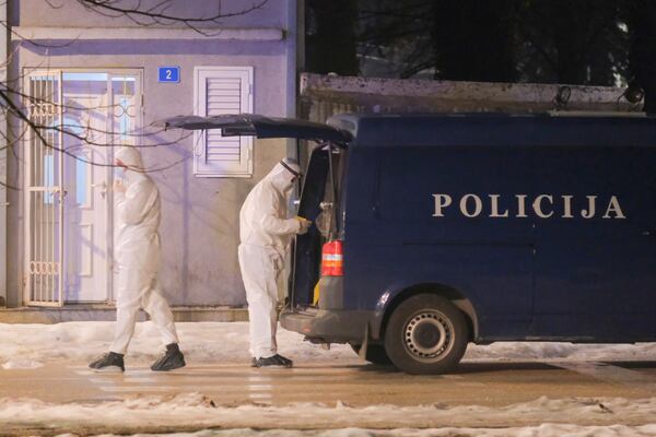 Police investigators work at the site of a shooting in Cetinje, 36 kilometers (22 miles) west of Podogrica, Montenegro, Wednesday, Jan 1, 2025. (AP Photo/Risto Bozovic)