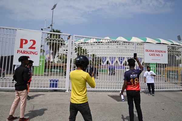 Fans take pictures outside the closed entrance of Atal Bihari Vajpayee Ekana Cricket Stadium after organizers suspended the Indian Premier League for one week following the escalating military tensions with Pakistan, in Lucknow, India, Friday, May 9, 2025. (AP Photo)