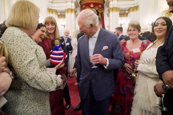 Britain's King Charles III speaks to guests during a reception in Buckingham Palace, London, in celebration of community-based initiatives raising awareness about cancer and supporting those living with cancer, Wednesday April 30, 2025. (Yui Mok/Pool Photo via AP)