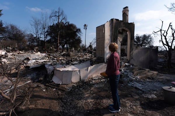 FILE - Louise Hamlin visits her home ravaged by the Eaton Fire in Altadena, Calif., Thursday, Jan. 30, 2025. (AP Photo/Jae C. Hong, File)