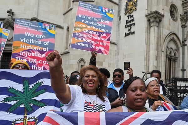 People demonstrate outside the High Court in London, Thursday, May 22, 2025, after a British court blocked the U.K. from transferring sovereignty over the Chagos Islands to Mauritius hours before the agreement was due to be signed. (AP Photo/Thomas Krych)