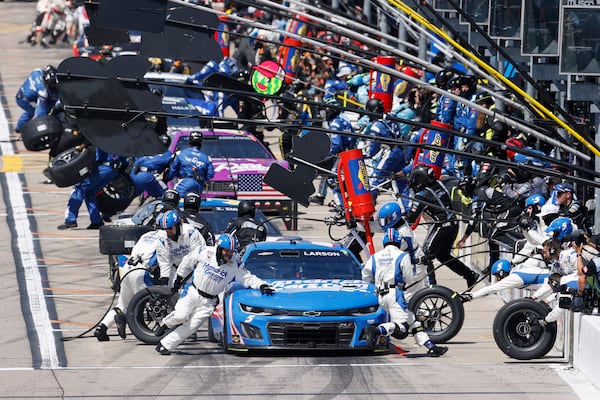 Kyle Larson, front, and other drivers stop on pit road at the end of the first stage during a NASCAR Cup Series auto race at Kansas Speedway in Kansas City, Kan., Sunday, May 11, 2025. (AP Photo/Colin E. Braley)