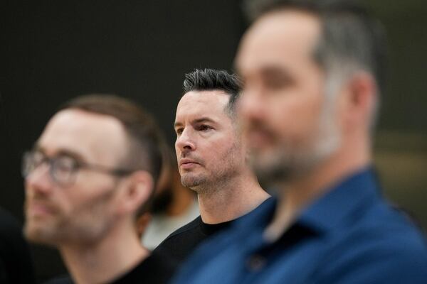 Los Angeles Lakers head coach JJ Redick listens to Luka Doncic speak during an introductory NBA basketball press conference Tuesday, Feb. 4, 2025, in El Segundo, Calif. (AP Photo/Jae C. Hong)