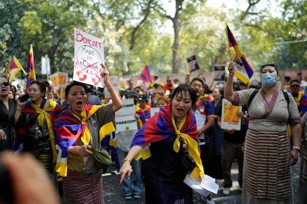 Exiled Tibetans shout slogans during a protest to commemorate the 1959 uprising in Tibet against the Chinese rule, in New Delhi, India, Monday, March, 10, 2025. (AP Photo/Manish Swarup)