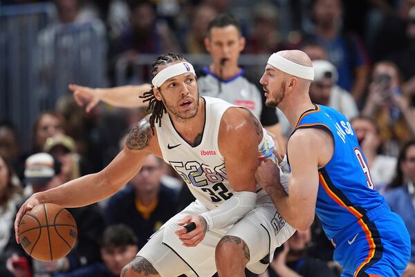 Denver Nuggets forward Aaron Gordon, left, looks to pass the ball as Oklahoma City Thunder guard Alex Caruso defends in the second half of Game 6 in the Western Conference semifinals of the NBA basketball playoffs Thursday, May 15, 2025, in Denver. (AP Photo/David Zalubowski)