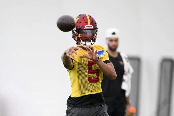 Washington Commanders quarterback Jayden Daniels works out during NFL football practice, Wednesday, May 28, 2025, in Ashburn, Va. (AP Photo/Nick Wass)